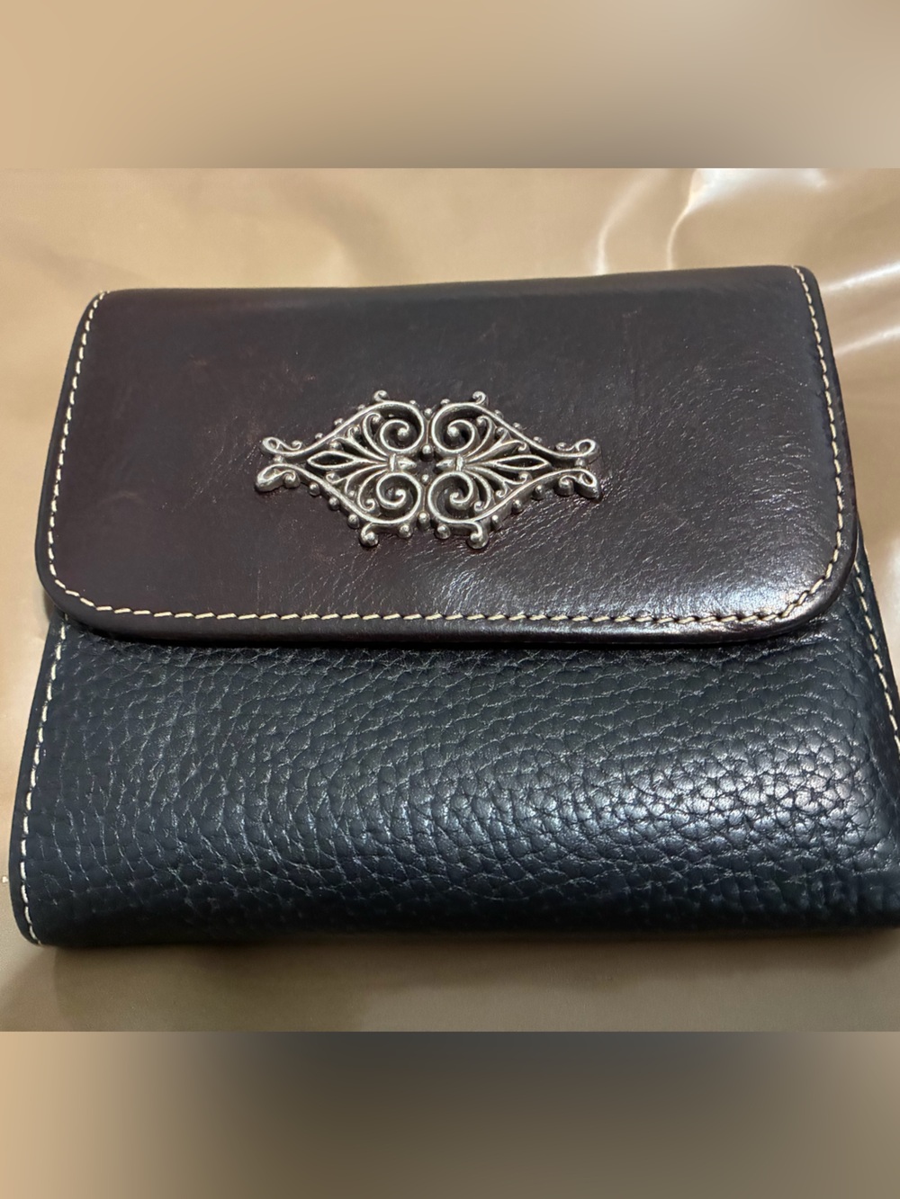 Women’s Black and Dark Brown Leather Wallet with Decorative Metal Emblem